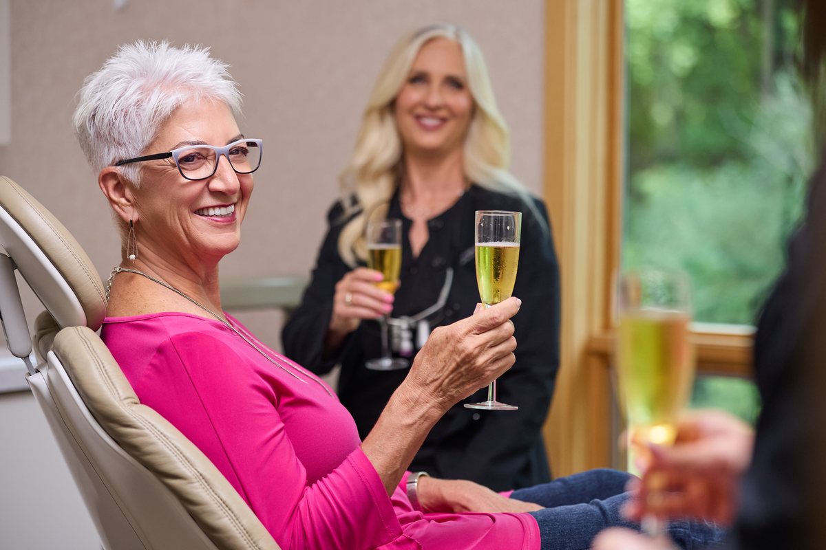 A patient celebrating her finished smile
